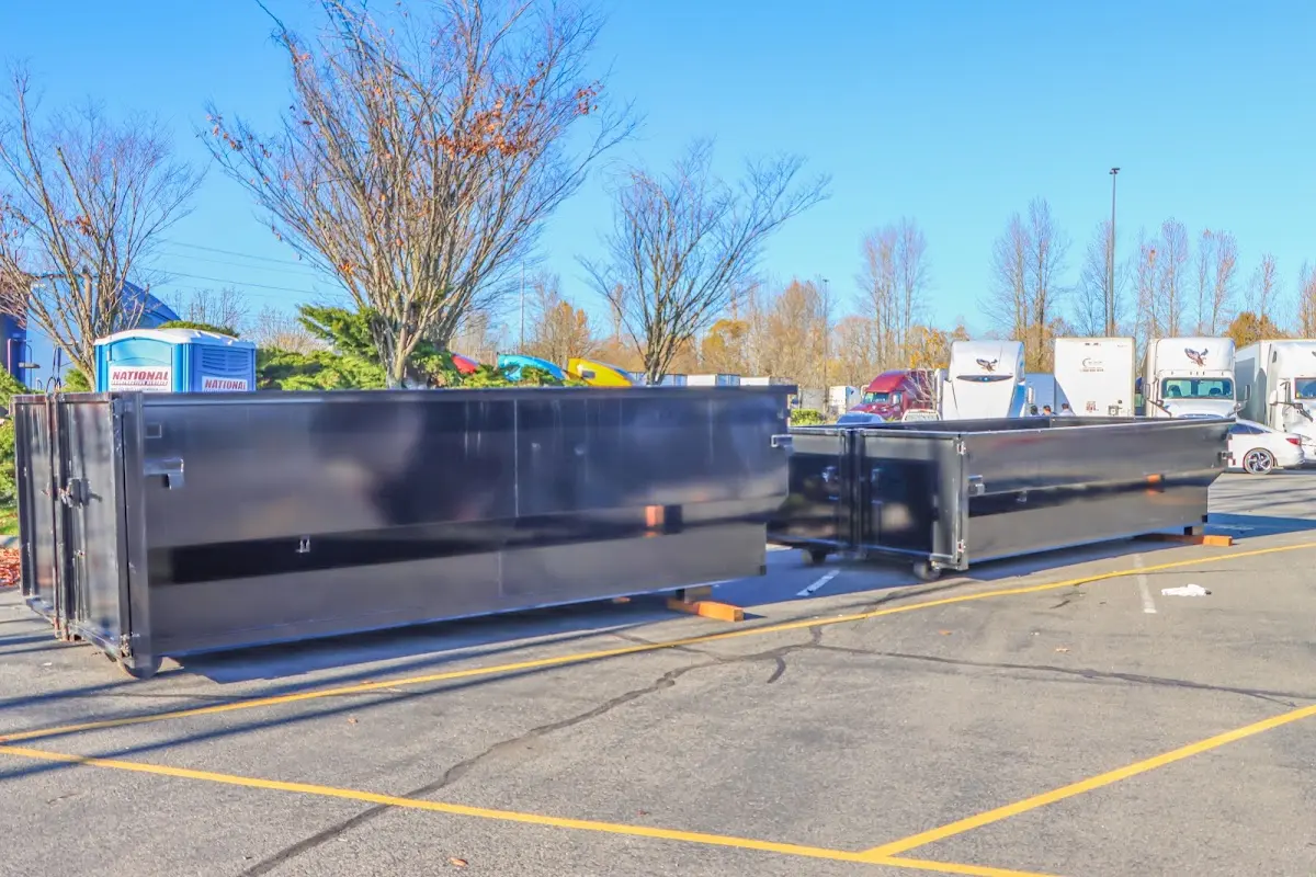 Professional dumpster rental service with roll-off container on residential driveway in Beavercreek